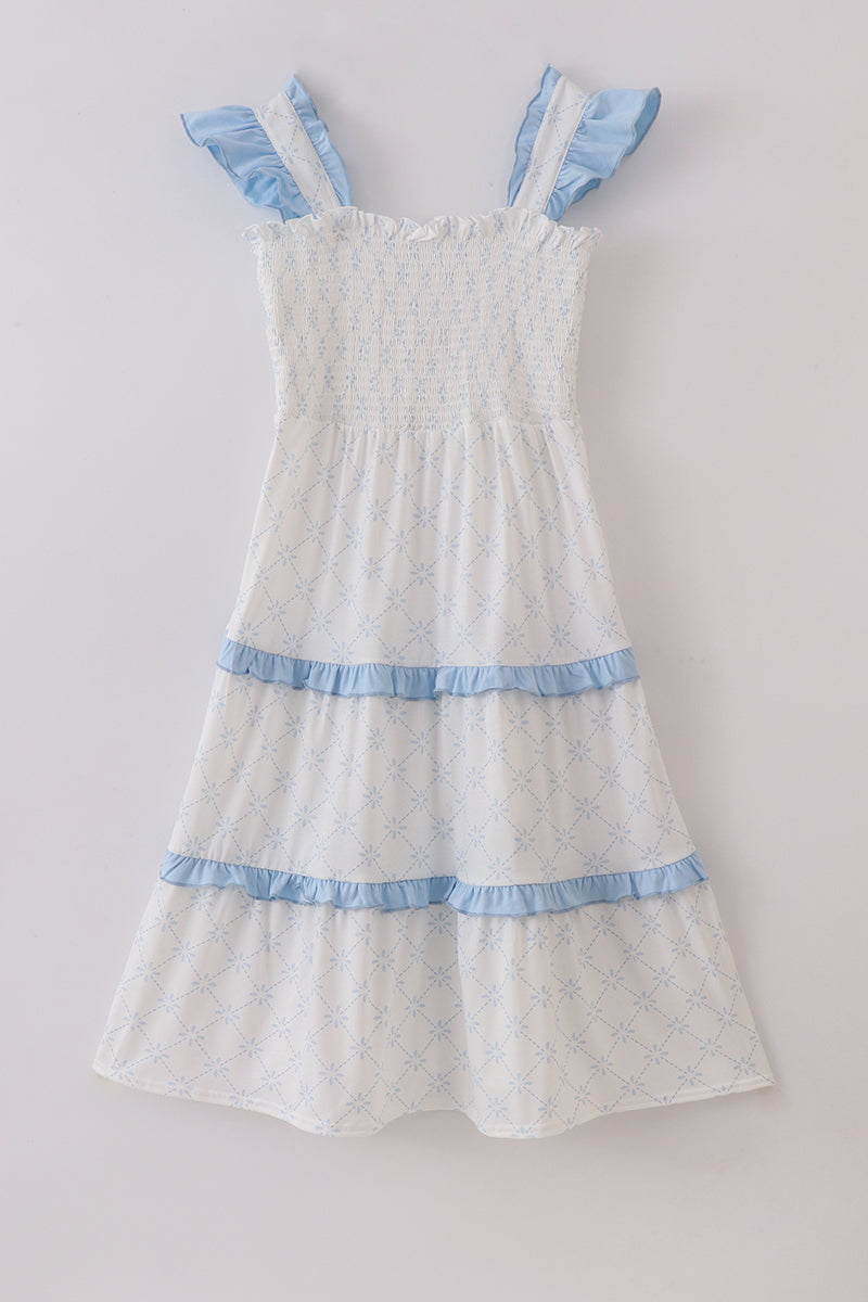 Blue tiered dress with classic lattice pattern, perfect for special occasions.