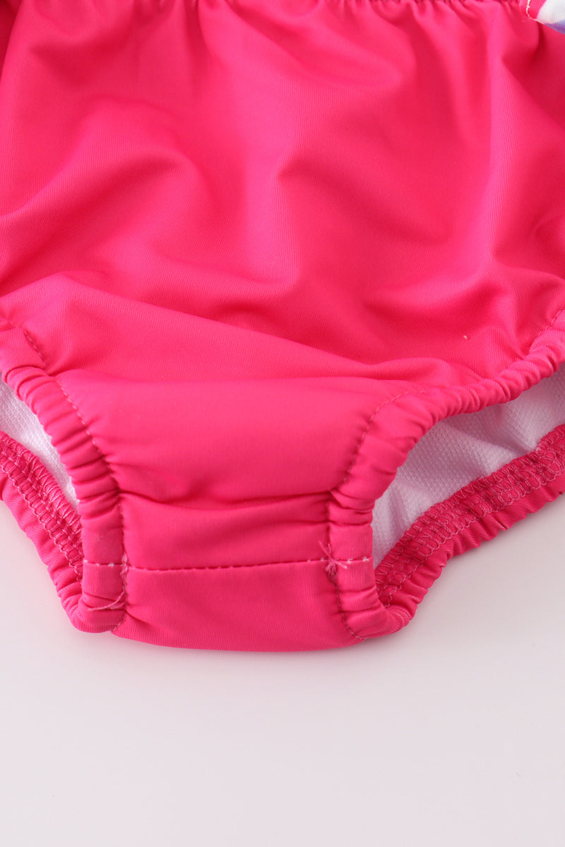 Bright pink two-piece swimsuit with reef print, perfect for beach adventures.