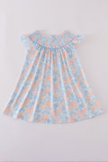 A charming blue smocked dress with floral ruffles, perfect for special occasions.