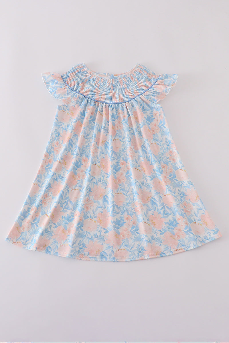A charming blue smocked dress with floral ruffles, perfect for special occasions.