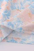 A charming blue smocked dress with floral ruffles, perfect for special occasions.