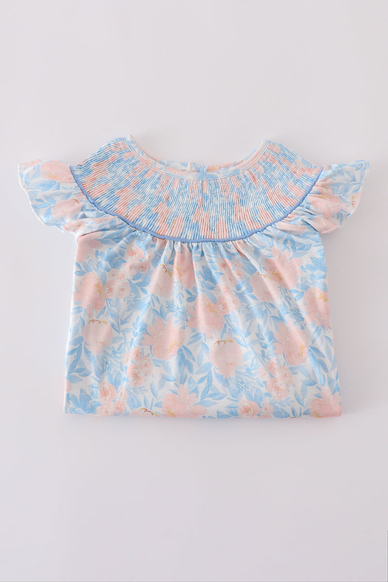 A charming blue smocked dress with floral ruffles, perfect for special occasions.