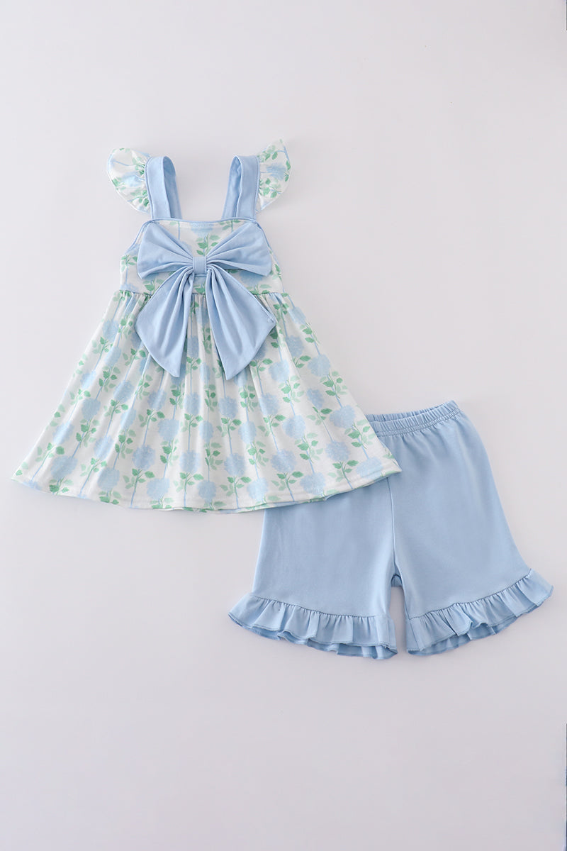 Adorable blue hydrangea print ruffle shorts set with a charming bow accent.