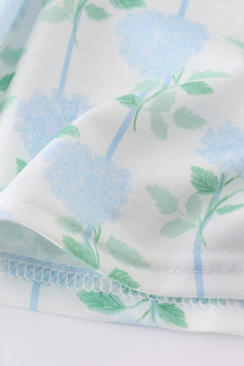 Adorable blue hydrangea print ruffle shorts set with a charming bow accent.