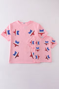 Matching pink tops adorned with shimmering star sequins, perfect for mother-daughter outings.