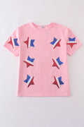 Matching pink tops adorned with shimmering star sequins, perfect for mother-daughter outings.