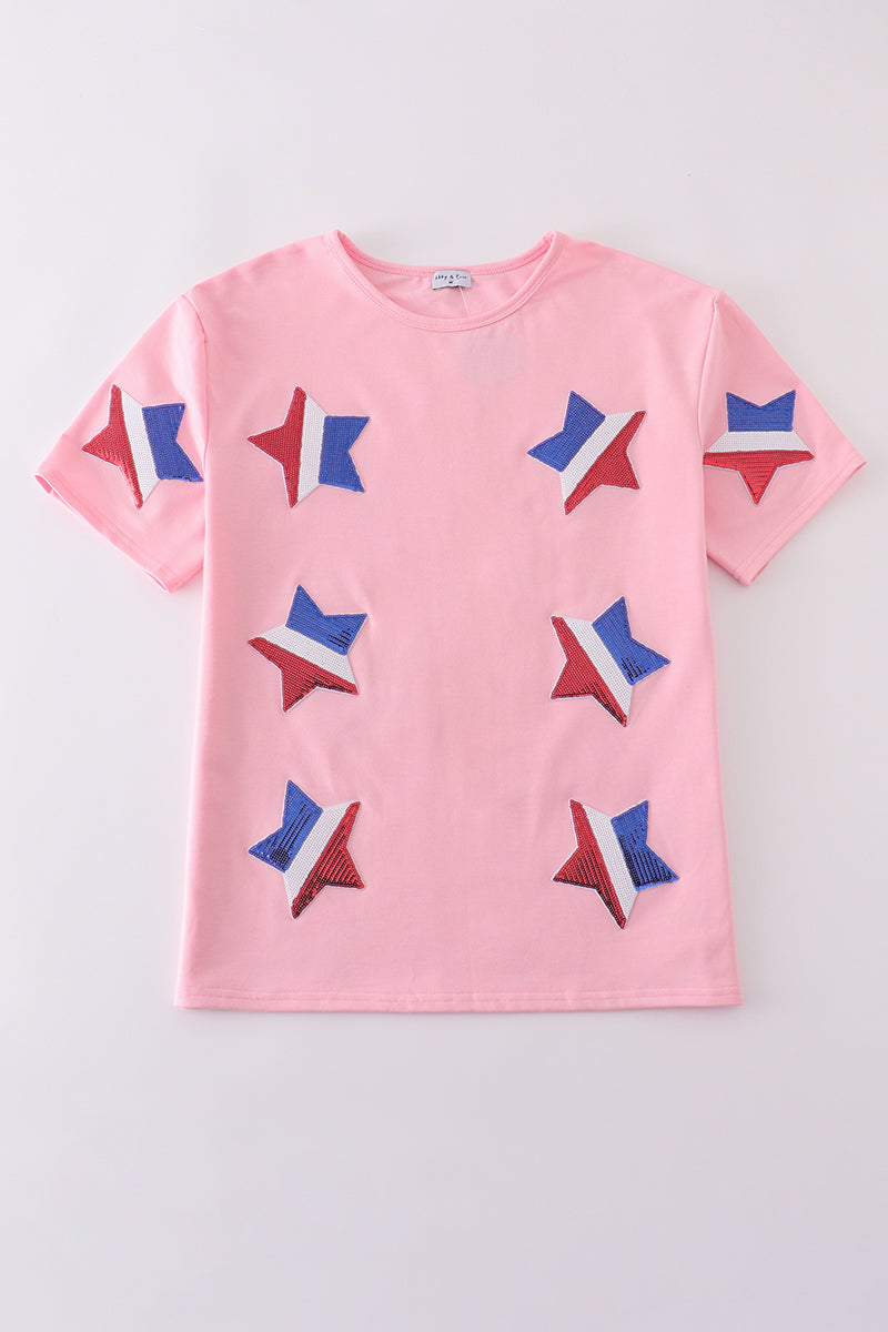 Matching pink tops adorned with shimmering star sequins, perfect for mother-daughter outings.
