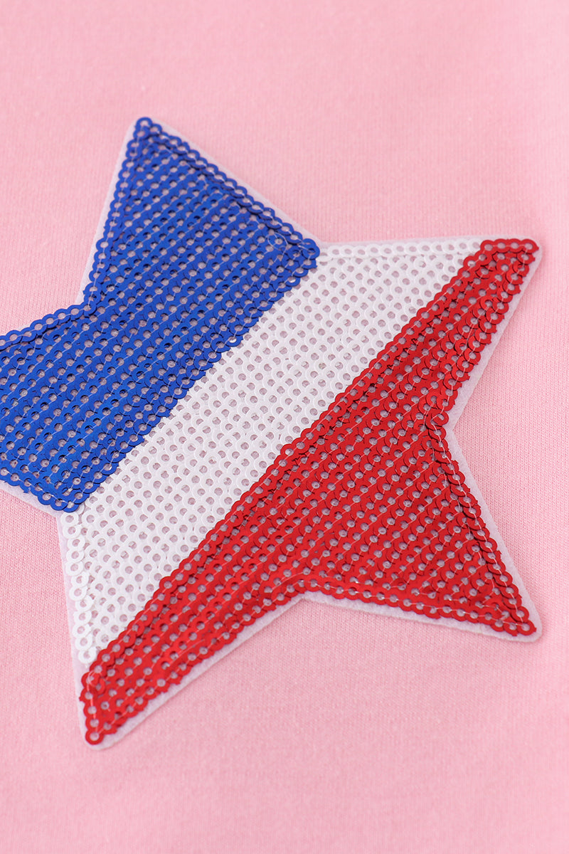 Matching pink tops adorned with shimmering star sequins, perfect for mother-daughter outings.