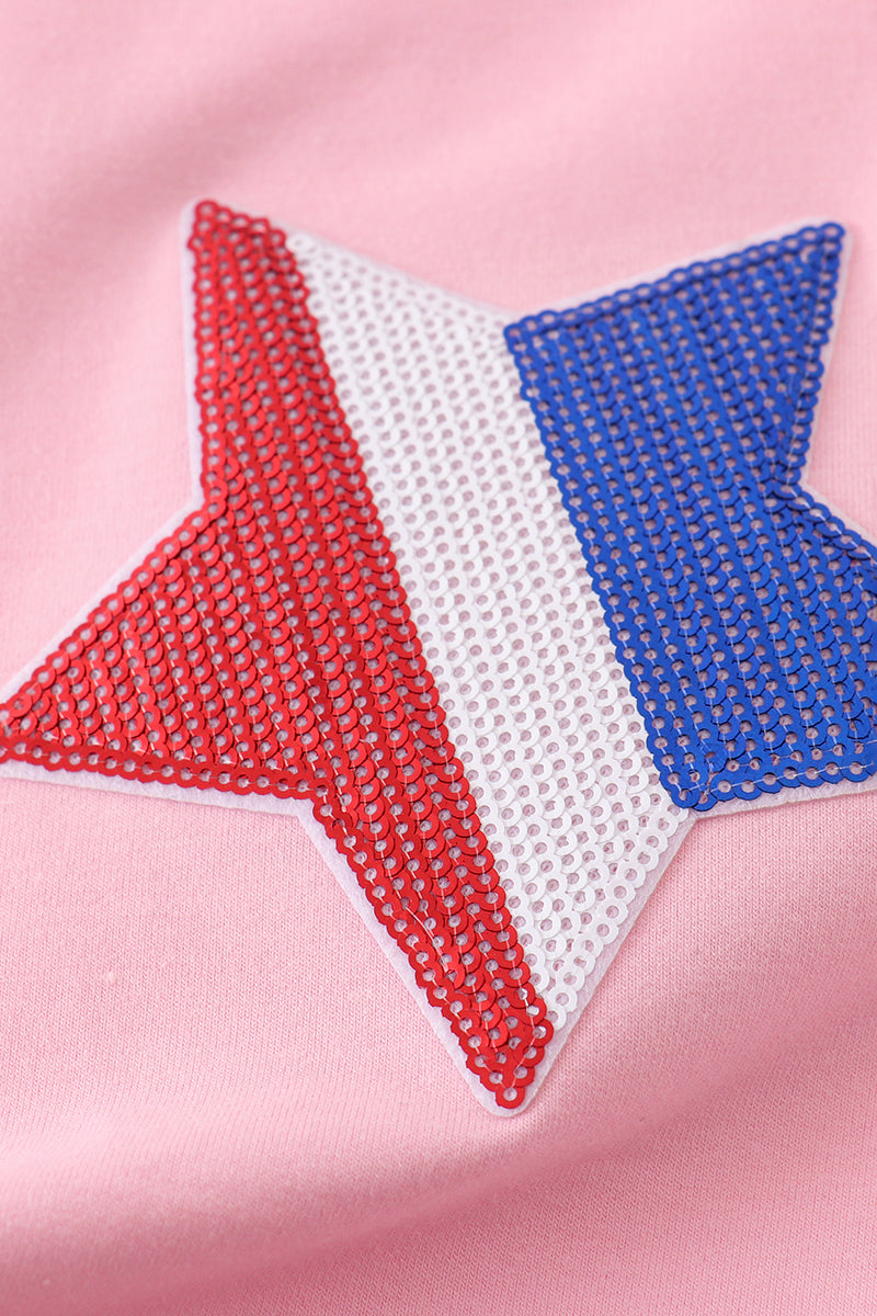 Matching pink tops adorned with shimmering star sequins, perfect for mother-daughter outings.
