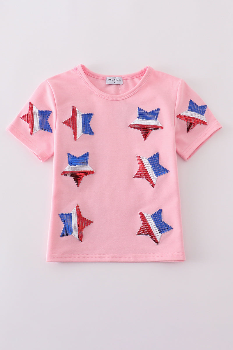 Matching pink tops adorned with shimmering star sequins, perfect for mother-daughter outings.