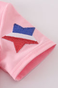 Matching pink tops adorned with shimmering star sequins, perfect for mother-daughter outings.