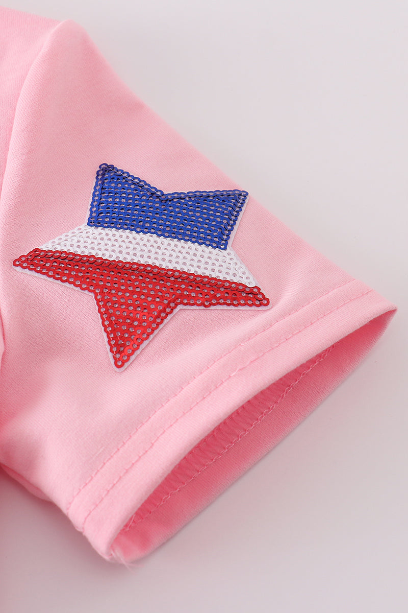 Matching pink tops adorned with shimmering star sequins, perfect for mother-daughter outings.