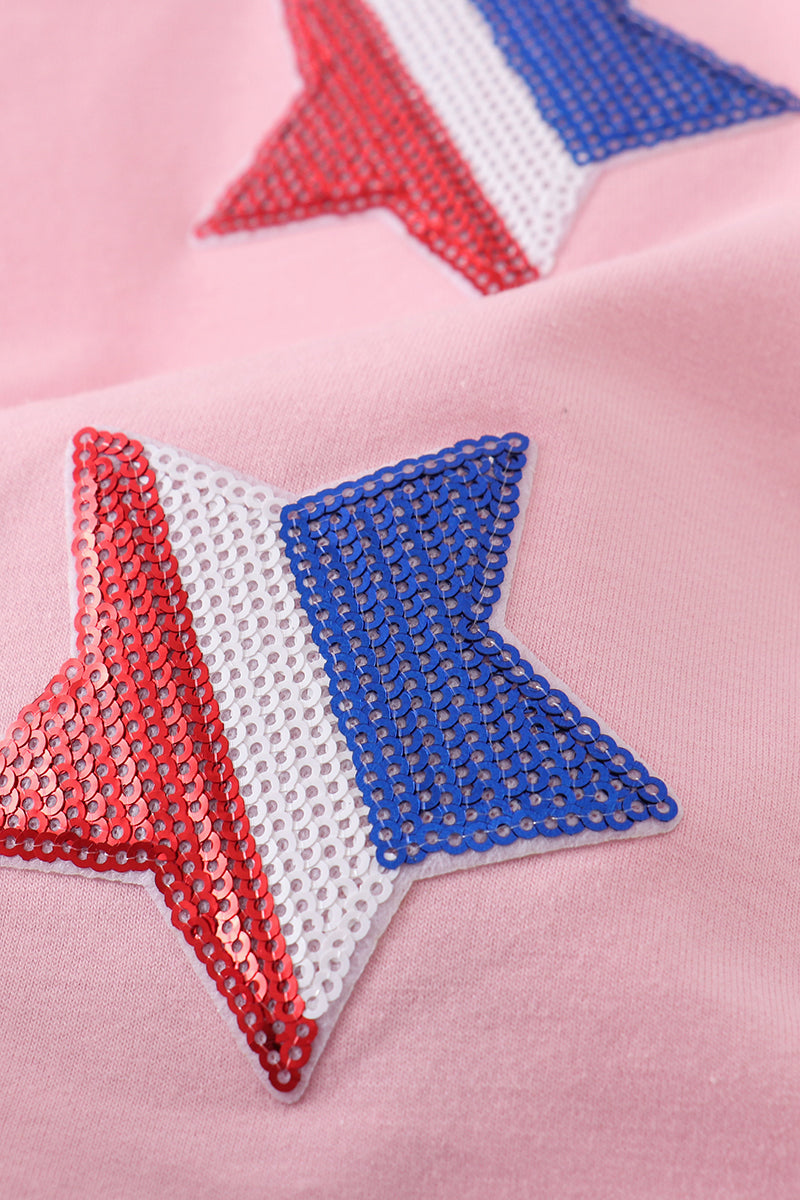 Matching pink tops adorned with shimmering star sequins, perfect for mother-daughter outings.