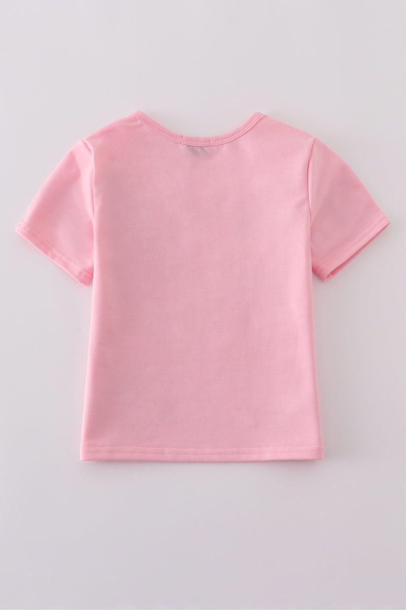 Matching pink tops adorned with shimmering star sequins, perfect for mother-daughter outings.