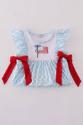 Blue gingham ruffle shorts set with flag embroidery and a matching bow.