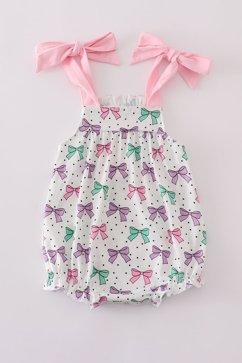 A sweet pink bubble romper with embroidered bow print, perfect for playtime.