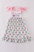 A charming pink dress with bow embroidery and playful ruffle details.