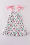 A charming pink dress with bow embroidery and playful ruffle details.