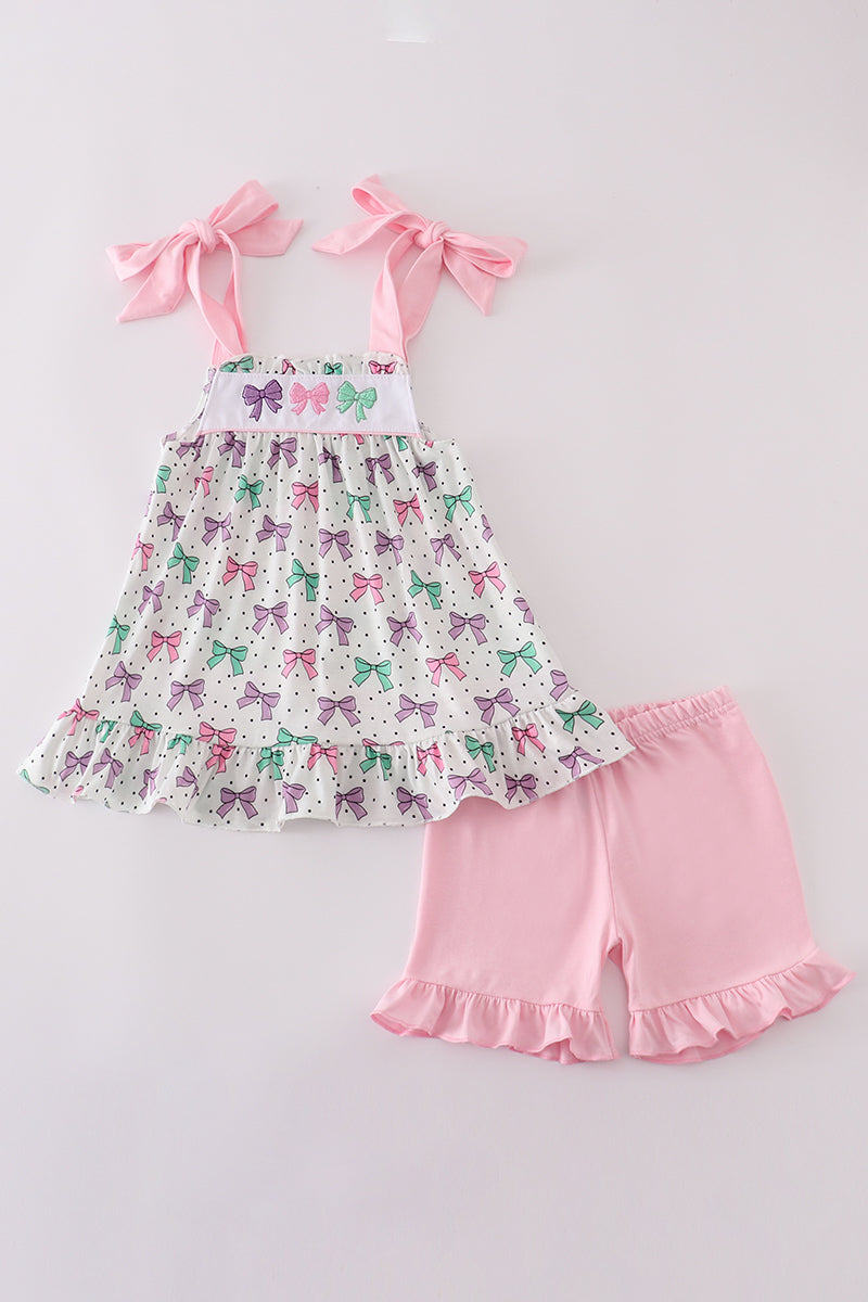 A cute pink ruffle shorts set with bow embroidery, perfect for playtime.