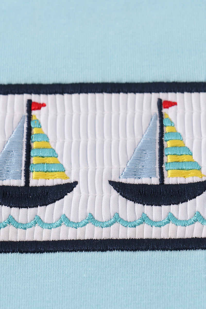 Toddler shorts set with blue sailboats embroidery and smocked detailing, perfect for summer.