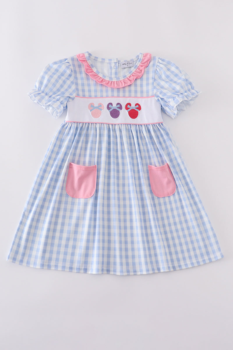 Blue gingham dress with ruffles and cute character embroidery, perfect for playtime.